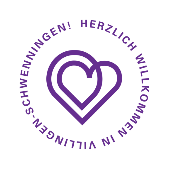 Lila/violette Stempel mit zwei überlappenden Herzumrissen in der Mitte; im Kreis der Schriftzug „Herzlich Willkommen in Villingen‑Schwenningen!“