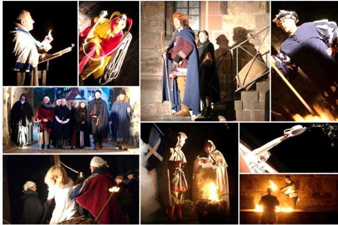 Balletttänzer in roten und weißen Kostümen führen eine Bühnenszene mit Feuer auf. (KI generiert)